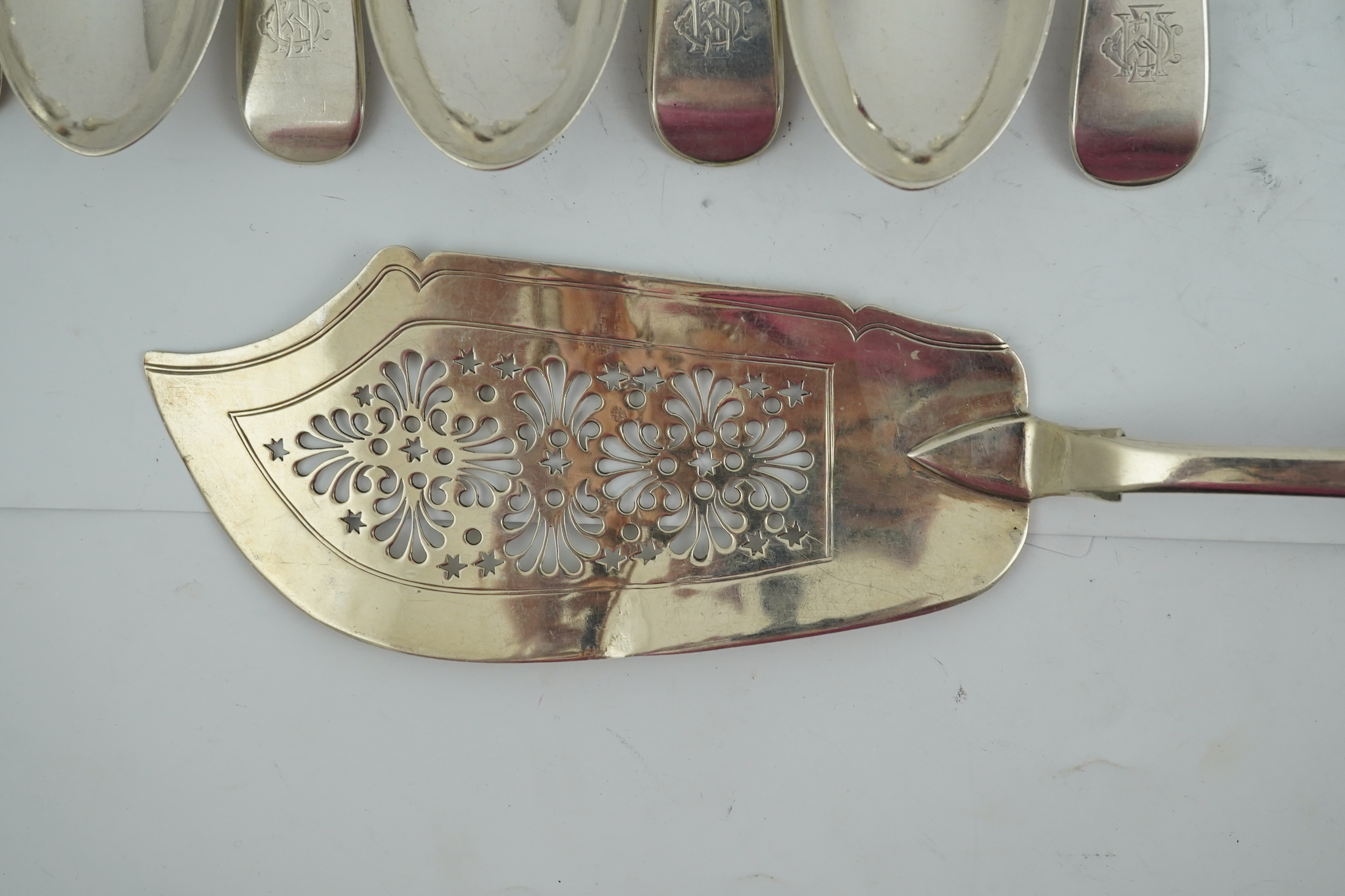 A matched set of seven late Victorian silver table spoons by Goldsmiths & Silversmiths Co Ltd (5) and Francis Higgins (2), London, 1894, together with a similar silver sauce ladle, two earlier silver table spoons and a W